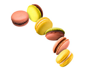 Set of flying french colorful macaroons isolated on white background