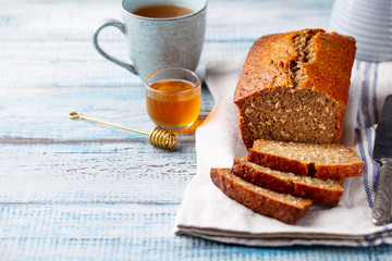 Healthy vegan oat and banana loaf bread, cake. Wooden background. Copy space.