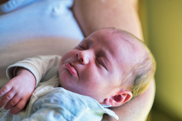 Woman embracing newborn baby outdoor