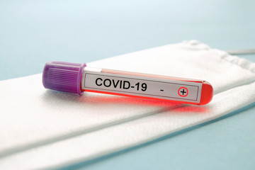 Fototapeta premium Positive test result COVID-19, novel coronavirus 2019 found in Wuhan, China. Test tube with a positive blood test for COVID-19. Laboratory study of a blood sample on COVID-19. Testing for 2019-nCoV.
