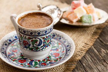traditional turkish coffee in porcelain cup with turkish delights, hot drink concept