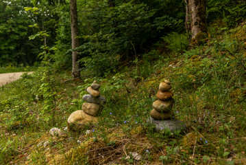 Various stone cairn in equilibrium in a Swiss forest in spring