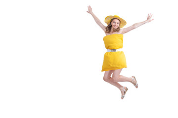 Woman in yellow pillow dress and hat happy jumps, flies and smiles in flight on white background. End of quarantine. Freedom and travel. Pillow Challenge due to stay home isolation. Copy space.