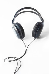 White background. On it are headphones for listening to music, black. Close-up
