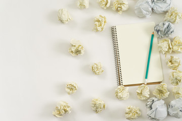 new ideas concept. notebook, paper balls, colorful pencils on white background.copy space