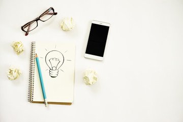new ideas concept. notebook with three bulb, paper balls, samrtphone, laptop, pencil. copy space