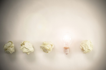 row of paper balls with shining bulb on it. creation concept