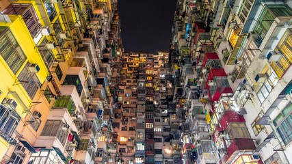 Hong Kong business district and density residential at night with light trails on the street movement.