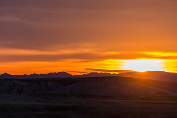 Landscape view of a colorful sunset in Badlands National Park in South Dakota).