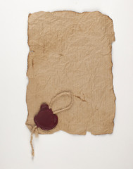 Old parchment or manuscript with red wax seal on a white background