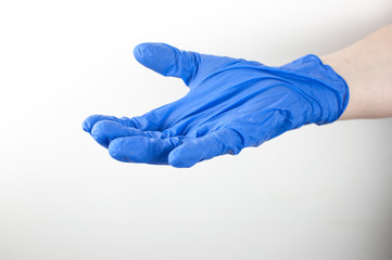 Shot of a doctor hand шт blue medical glove with palm up on a white background