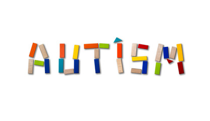 Concept of autism. Wooden word on colored background