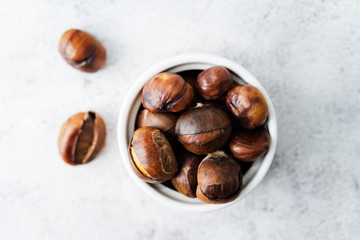 Chestnuts peeled and peeled in a white bowl