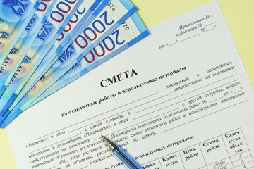 Preparation and approval of estimates for construction and finishing works. Russian text "Estimate", rubles and pen on the table