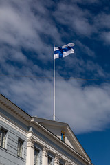 Fototapeta na wymiar Finnish flag flying high in Helsinki on national holiday