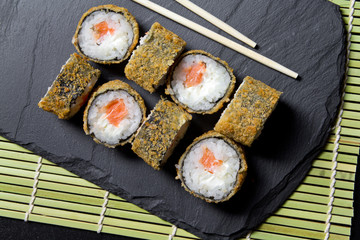 Sushi roll tempura with prawns. Top view of sushi . Sushi food photo for menu.