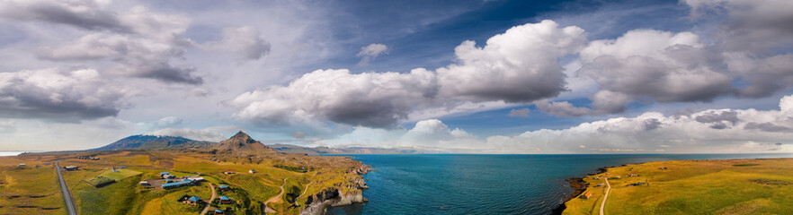 Arnarstapi coastline in sumemr season, Snaefellsnes peninsula, Iceland. Panoramic aerial view from drone at sunset