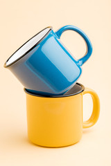 blue and yellow iron Cup, on a yellow background.