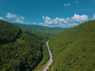 Fototapeta premium Aerial view of a rural highway between mountains