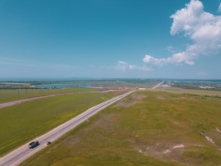 Road Construction Site near the highway with machinery, bulldozer, excavation from above. 4K video, top down view.