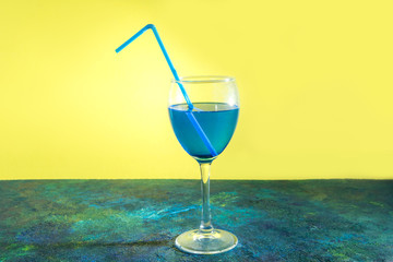 Blue cocktail on yellow blue background.
