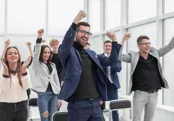 jubilant group of young people applauds in the conference room