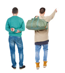 Back view of two man in sweater pointing.