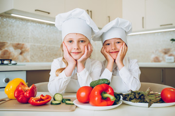 little cooks cut vegetables for salad