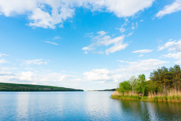 Obraz na płótnie Canvas Water reservoir, forest and beautiful cloudy sky, calm landscape photography.