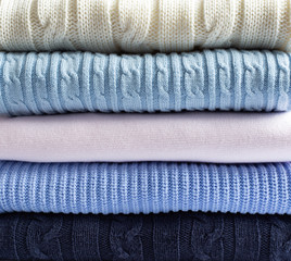 Pile of light pastel woolen clothes