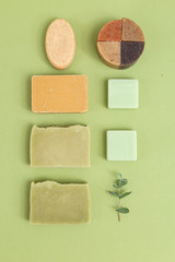 Natural soap and  eucalyptus on green background. Self-care. Minimalism. Vertical format