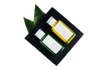 Mockup of a colored green and yellow lotions in transparent bottles