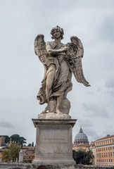 Fototapeta na wymiar Full size statue of Angel with the Crown of Thorns on Ponte Sant'Angelo in Rome near Castel Sant'Angelo