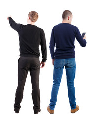 Back view of two man in sweater with mobile phone.