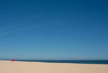 Landscape view of San Jose del Cabo( Saint Joseph of the Cape)  beach with red flag, Do Not Swim Concept