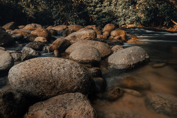 Smooth waterfall on dark-colored rocks
