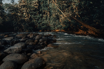 Smooth waterfall on dark-colored rocks