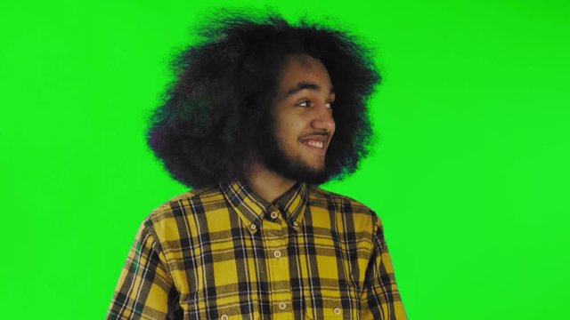 Disappointed afro american male doing facepalm gesture against green screen or chroma key background. Concept of emotions