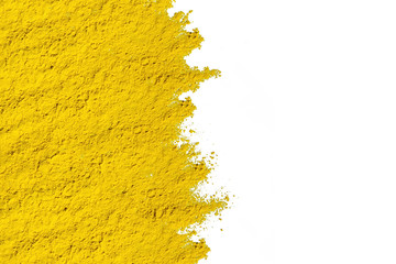 Abstract background of yellow dry powder paint. Copy space in a right side.