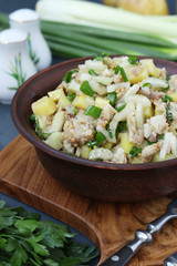 Salad with potatoes, mackerel and celery, seasoned with mustard and olive oil, Vertical format