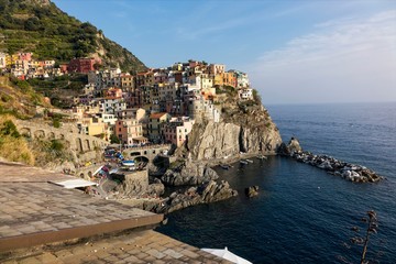 view of Manarola vilage in Cinque Terre with it's marvelous vivid houses on rocks near the sea - Powered by Adobe