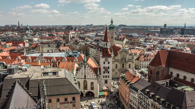 Timelapse of beautiful view of the city of Munich and the clock tower of St. Peter's Church at day time. Munich, Germany