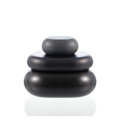 Fototapeta na wymiar Pyramid of black basalt zen stones for hot massage isolated on white.