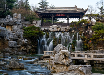 Waterfall under a traditional Chinese pavilion