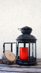 Black glass candle holder, Red candle and timber on a white background