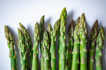 Green asparagus sticks isolated on white background. Studio shot. Vegetables: Asparagus Isolated on White Background. Fresh ripe asparagus on a white background