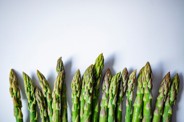 Extreme close-up image of fresh asparagus on white background. Vegetables: Asparagus Isolated on White Background. Fresh ripe asparagus on a white background