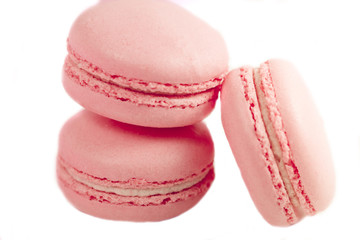 Delicious french dessert. Three gentle pastel soft pink cakes macaron or macaroon isolated on a white background