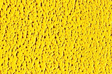 Texture of yellow color of artistic plaster. Concept of abstraction of mountains and waves.