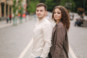 Happy couple walking in the city. Attractive young woman and handsome young man in centre of the city. Smiled people